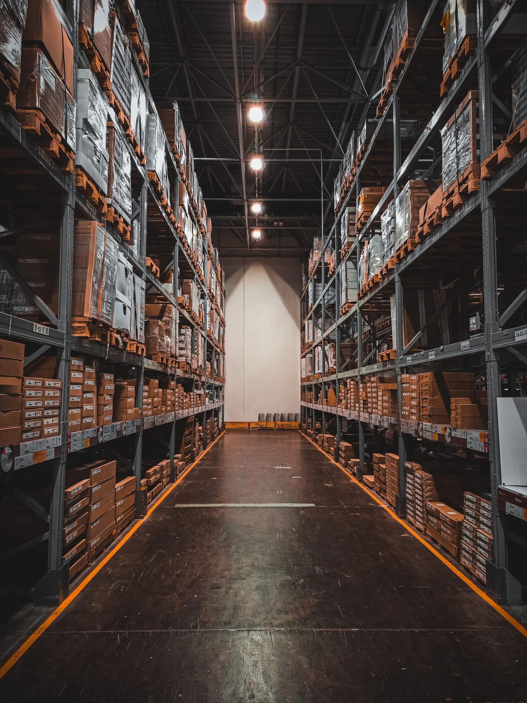 Aisle of a distribution warehouse with stacked pallets
